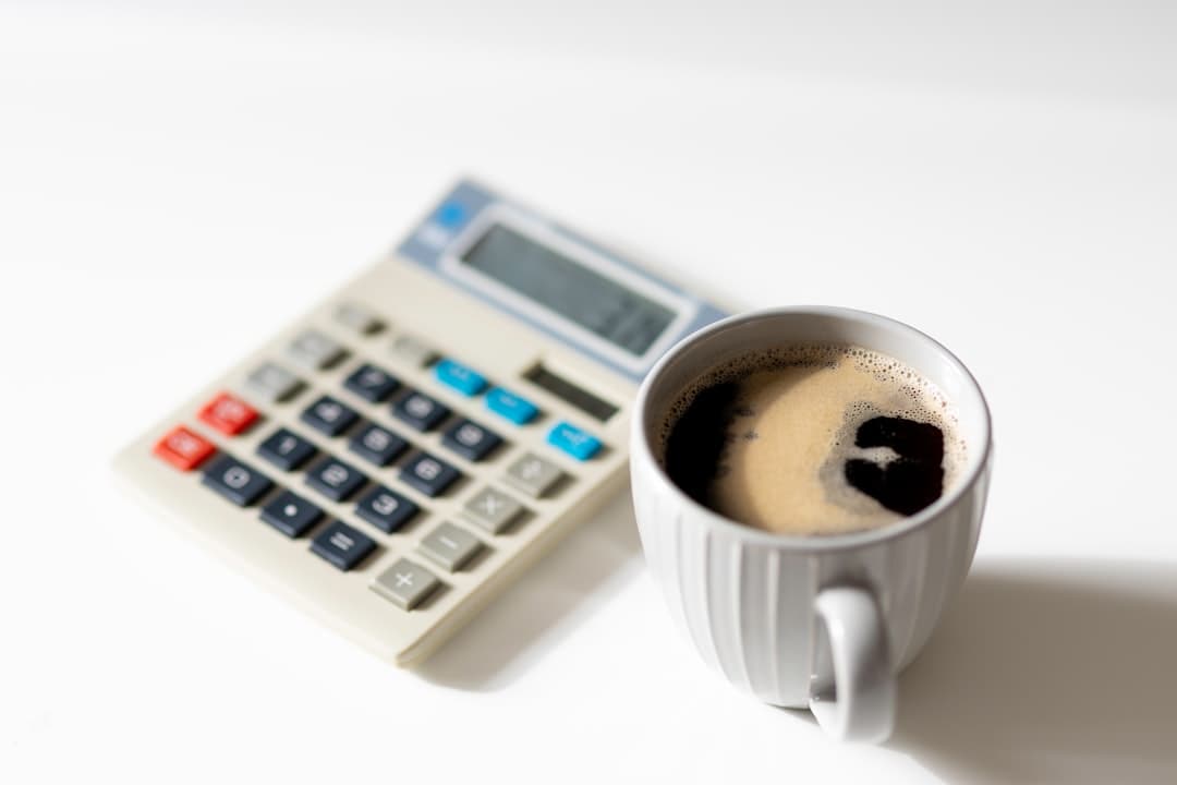 blueprints with calculator and coffee